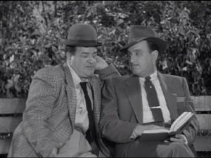 Lou Costello and Bud Abbott sitting on a bench in The Tax Return - The Abbott and Costello Show season 2