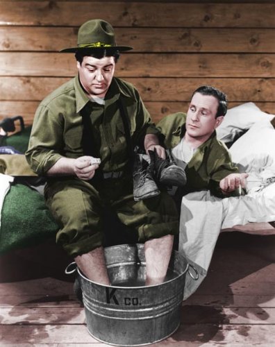Bud Abbott and Lou Costello soaking their feet in a colorized photo from Buck Privates