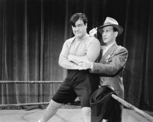 Lou Costello in the ring, getting instructions from Bud Abbott, before facing off against Lon Chaney Jr. in "Here Come the Co-Eds"