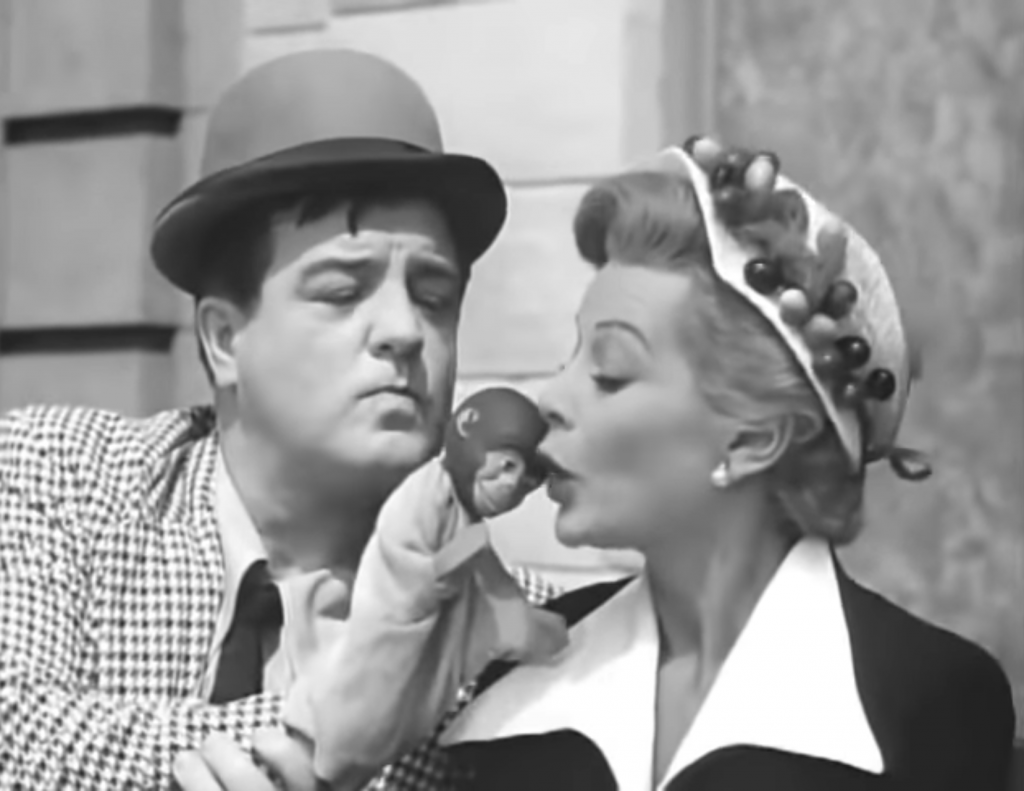 Lou Costello flirting with a pretty young woman on a bench