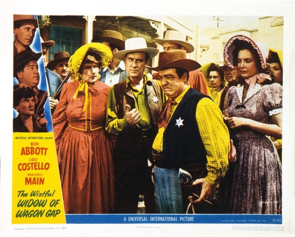 Color lobby card for "The Wistful Widow of Wagon Gap" with the main cast: Marjorie Main, Bud Abbott, Lou Costello