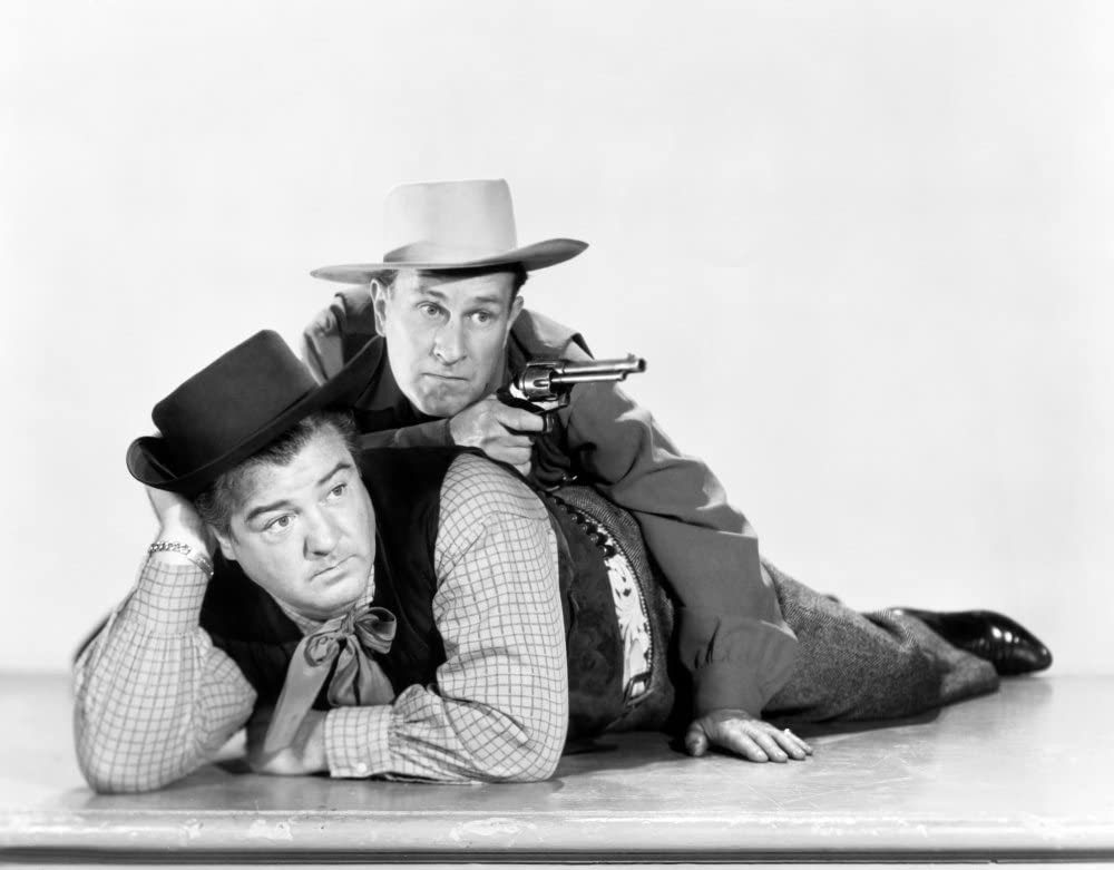 Lou Costello and Bud Abbott in a promotional photo for "The Wistful Widow of Wagon Gap" - Lou lying down, Bud using his as cover