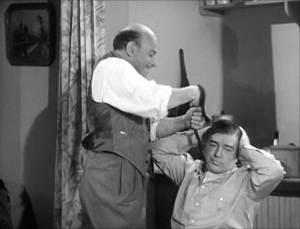 Sid Fields trying to pull Lou Costello out of the hole in "Alaska"