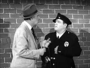 Lou in Mike the Cop's uniform, as part of a scam in "The Wrestling Story"