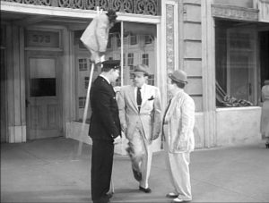 Bingo the Chimp on stilts, while Mike the Cop talks with Bud and Lou. "It's over my head."