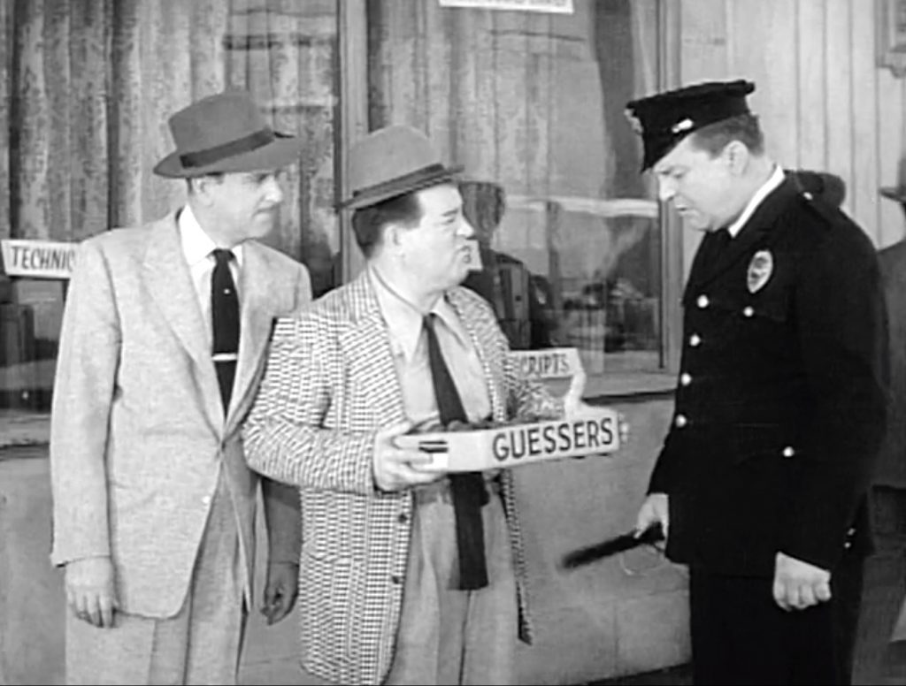 Chocolate guessers - Lou Costello cons Mike the Cop while Bud Abbott watches in "Little Old Lady"