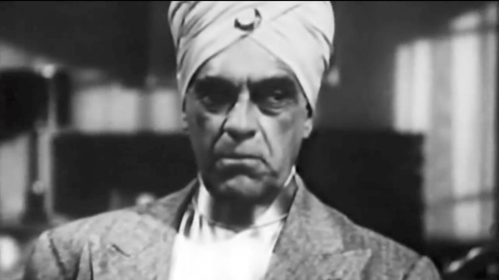 Boris Karloff as The Swami