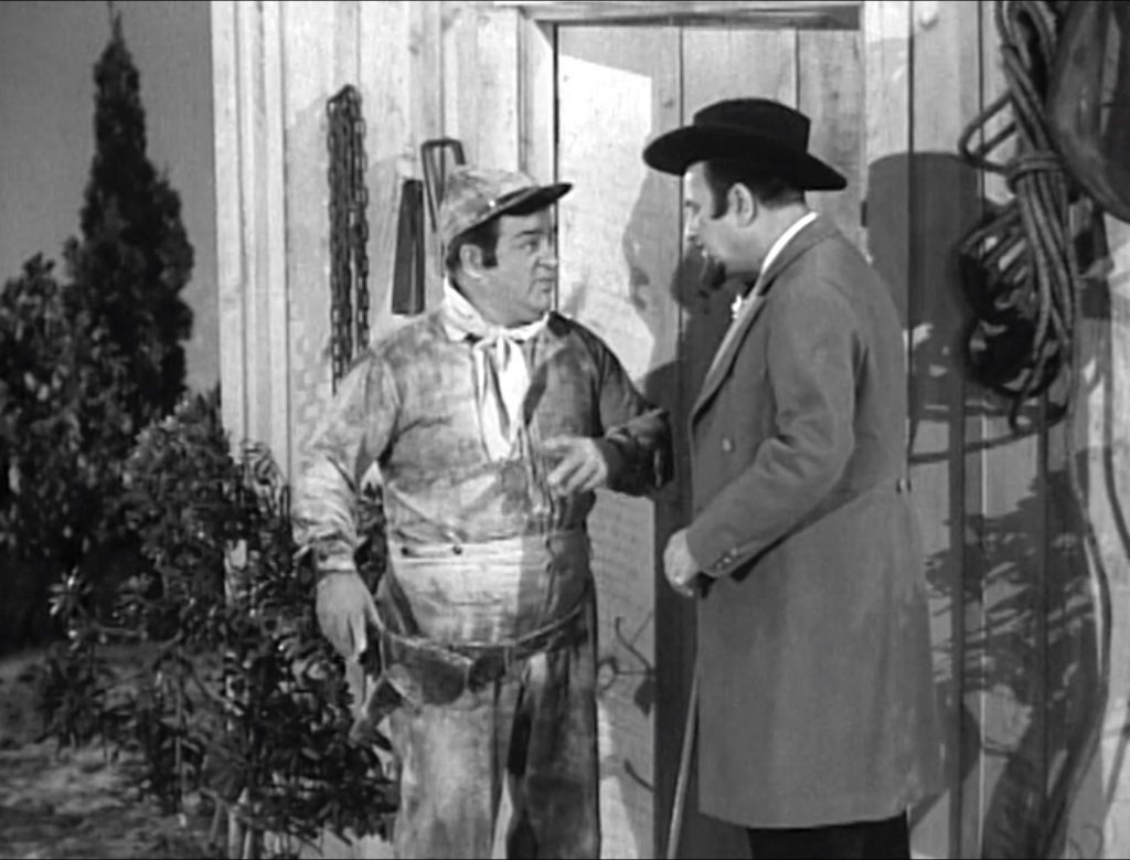 Lou Costello and Bud Abbott plan outside the shack in "South of Dixie"