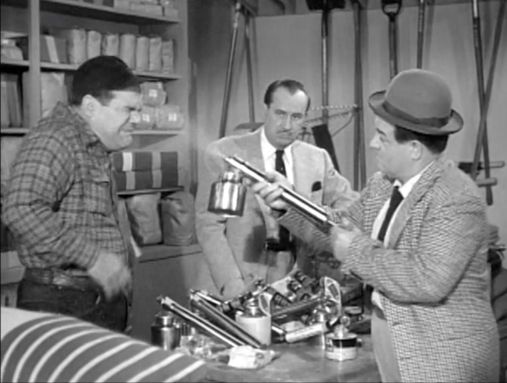 Lou Costello sprays Dick Wessel in the plant nursery in "From Bed to Worse"
