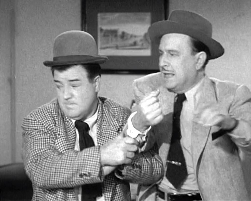 Lou Costello handcuffed to Bud Abbott in "Private Eye"