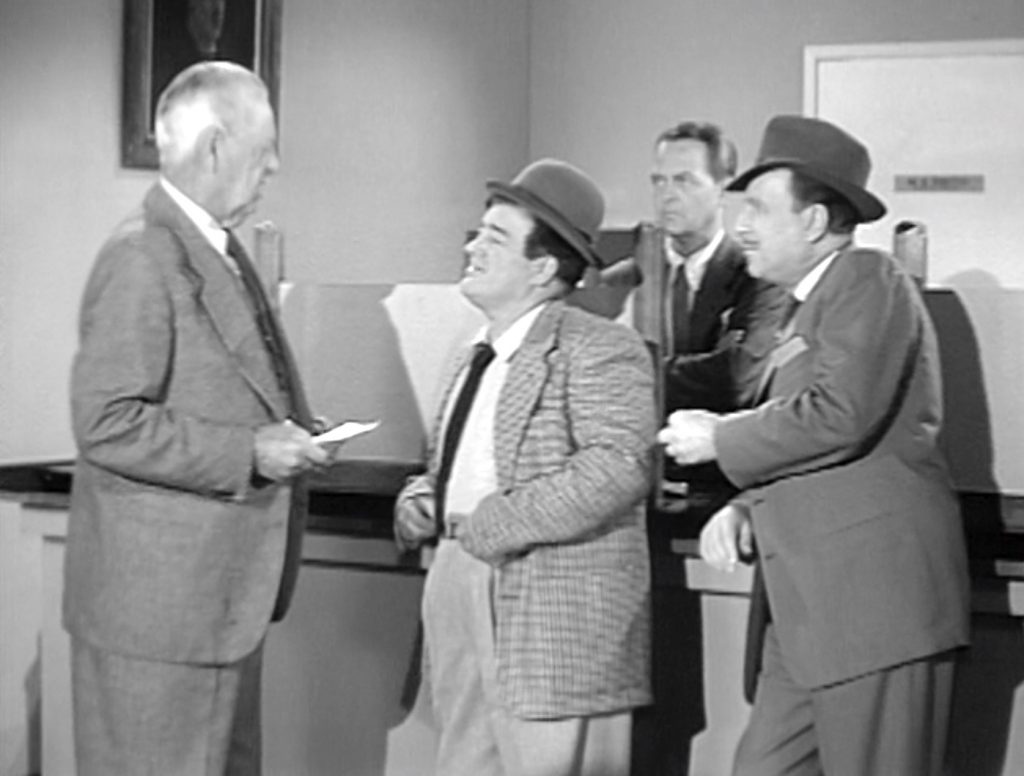 At the bank, trying to cash Lou Costello's million dollar check in The Tax Refund