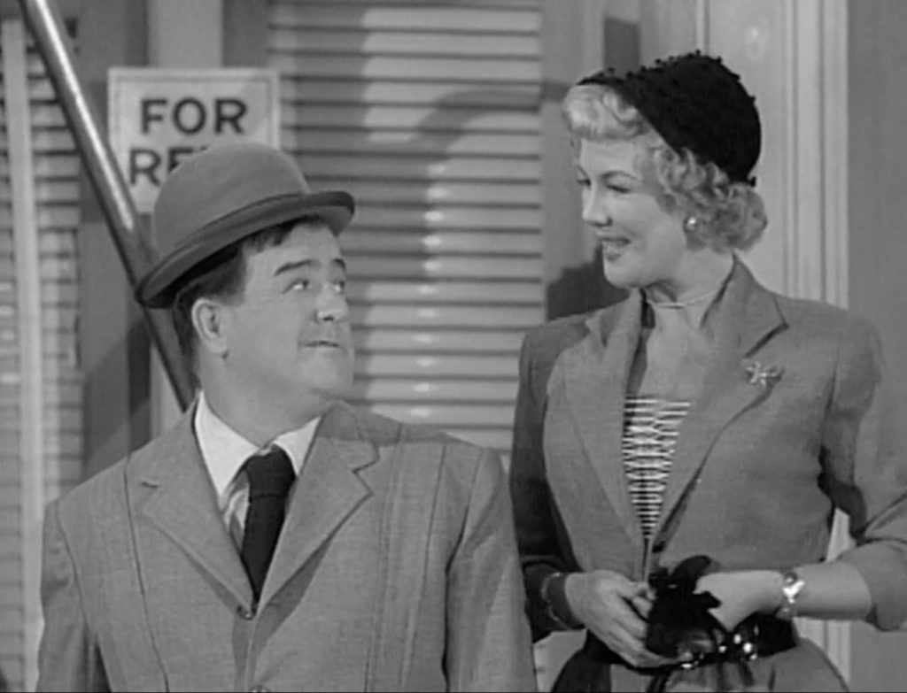 Lou Costello gives a free weight to a pretty young lady in "Public Enemies"