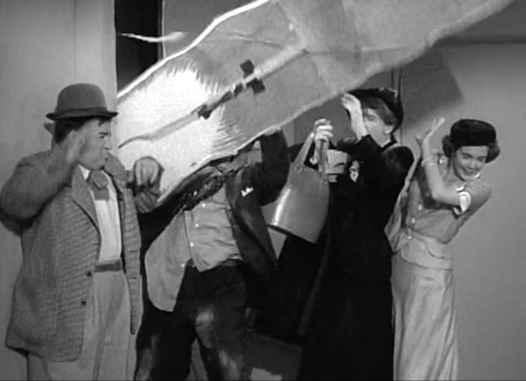 The angry Mr. Davis grabs a wall light to hit Lou Costello with - and the wall comes with it!