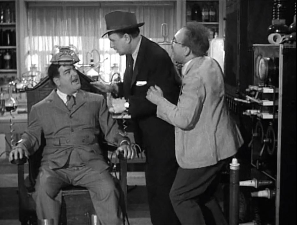 Lou Costello being strapped into the mad scientist's machine -- with Bud Abbott's help!