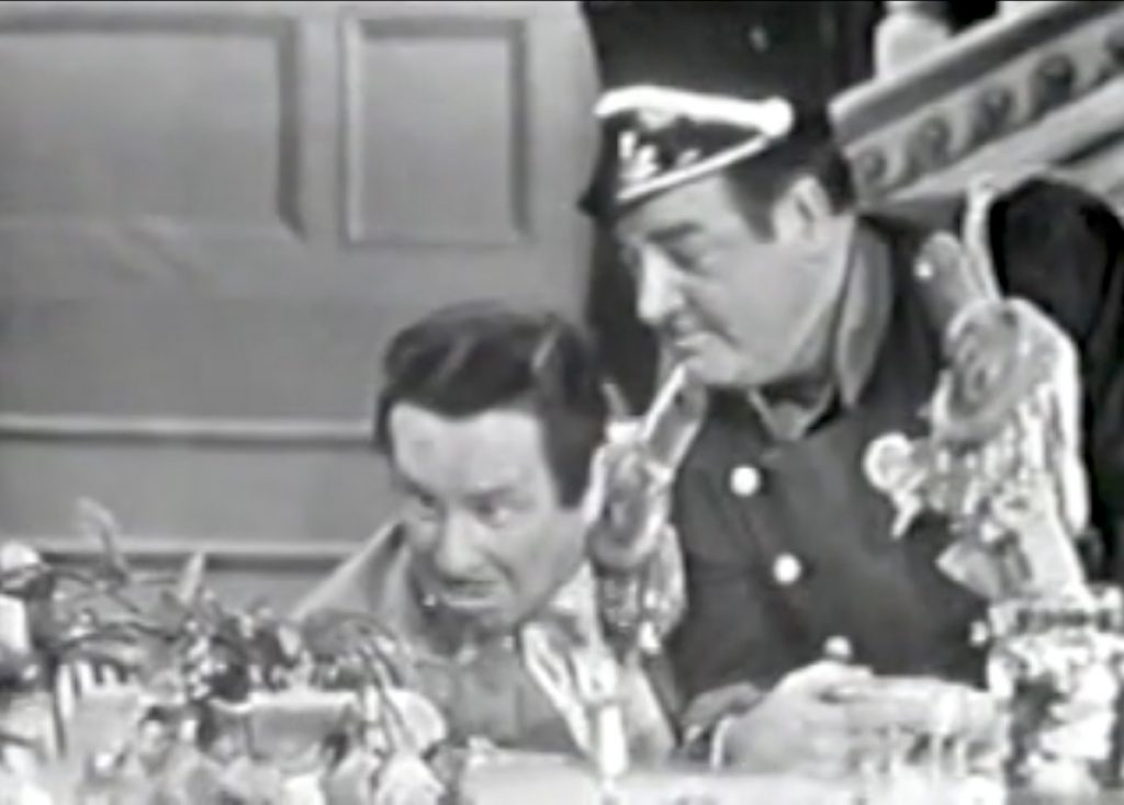 Suspicious Lou Costello pours his soup into the flower vase - and the flowers wilt and die, as Bud Abbott watches