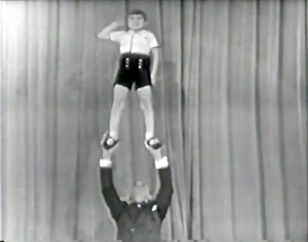 Paul Remos doing acrobatics with one of his toy boys