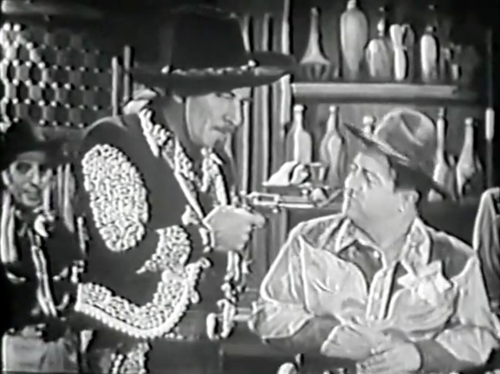 Black Pedro (Errol Flynn) threatens Sheriff Lou Costello at gunpoint!