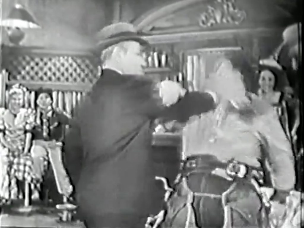 George Raft pushes Lou Costello into the table